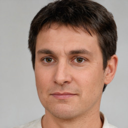 Joyful white adult male with short  brown hair and brown eyes