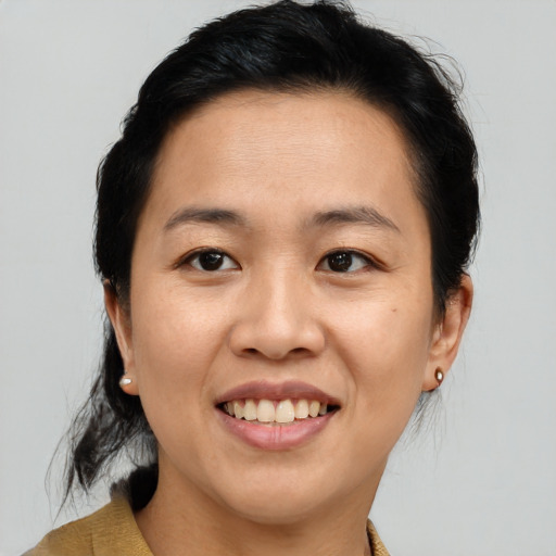 Joyful asian young-adult female with medium  brown hair and brown eyes