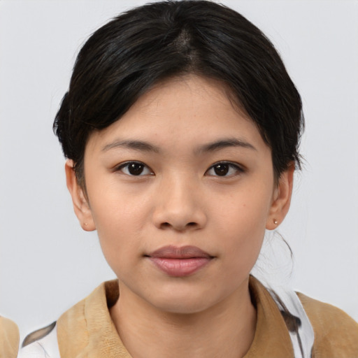 Joyful asian child female with medium  brown hair and brown eyes