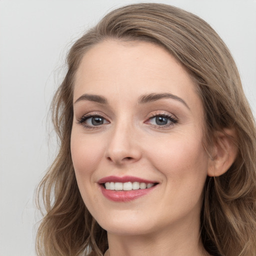 Joyful white young-adult female with long  brown hair and grey eyes