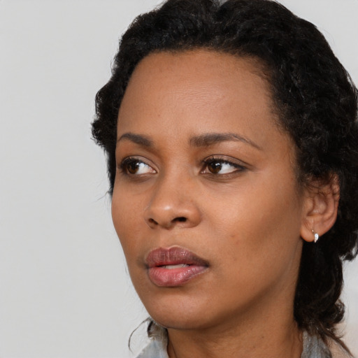 Neutral black young-adult female with long  black hair and brown eyes
