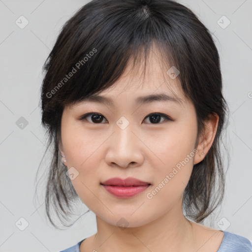 Joyful asian young-adult female with medium  brown hair and brown eyes