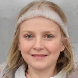 Joyful white young-adult female with medium  brown hair and blue eyes