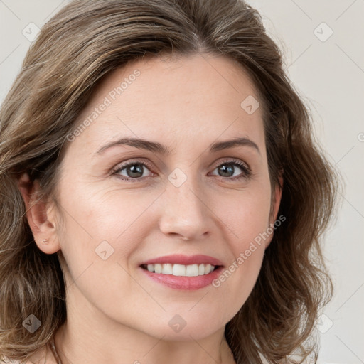 Joyful white young-adult female with long  brown hair and green eyes