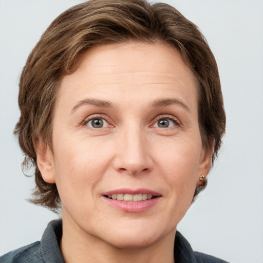 Joyful white adult female with medium  brown hair and grey eyes