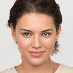 Joyful white young-adult female with medium  brown hair and brown eyes