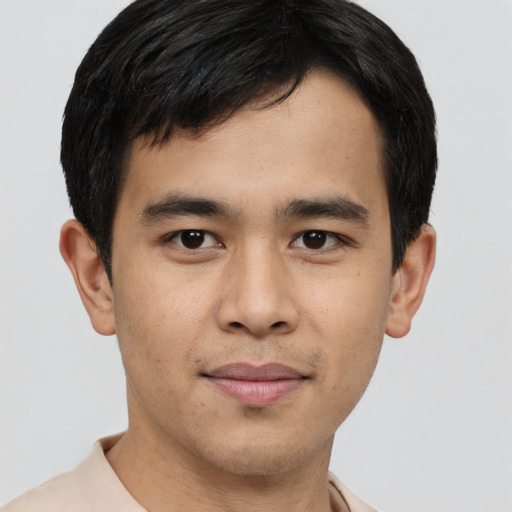 Joyful latino young-adult male with short  brown hair and brown eyes