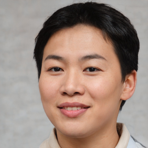 Joyful asian young-adult female with short  brown hair and brown eyes