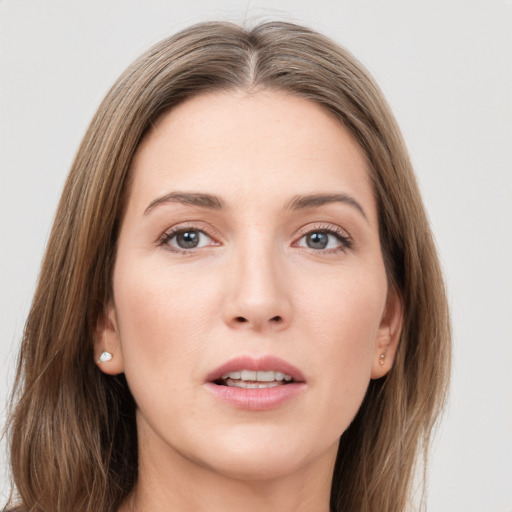 Joyful white young-adult female with long  brown hair and grey eyes