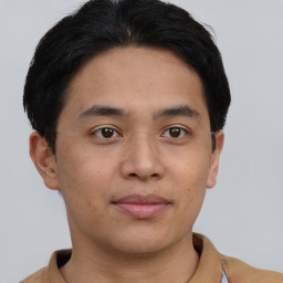 Joyful latino young-adult male with short  brown hair and brown eyes