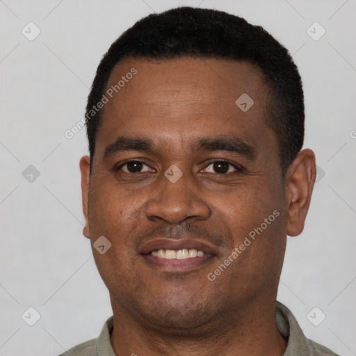 Joyful black young-adult male with short  black hair and brown eyes