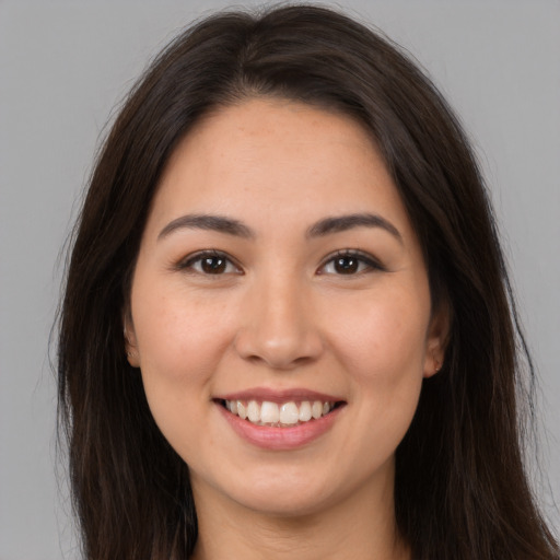 Joyful white young-adult female with long  brown hair and brown eyes