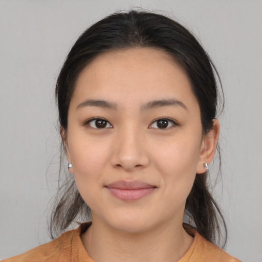 Joyful latino young-adult female with medium  brown hair and brown eyes