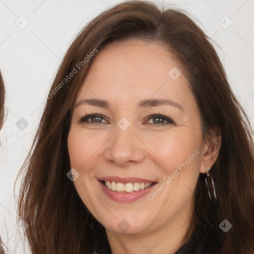 Joyful white adult female with long  brown hair and brown eyes