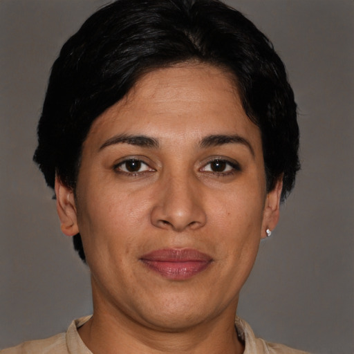 Joyful latino adult female with short  brown hair and brown eyes