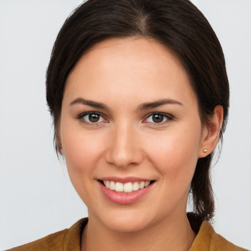 Joyful white young-adult female with medium  brown hair and brown eyes