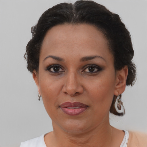 Joyful black adult female with short  brown hair and brown eyes