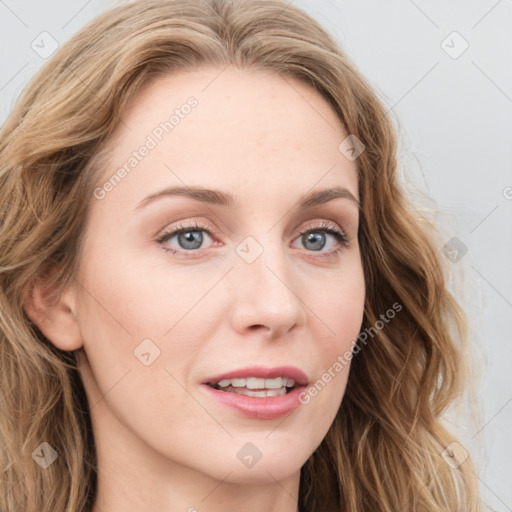 Joyful white young-adult female with long  brown hair and blue eyes