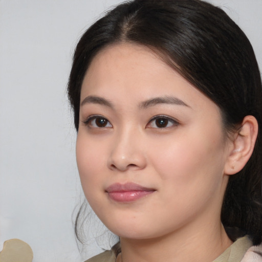 Joyful asian young-adult female with medium  black hair and brown eyes