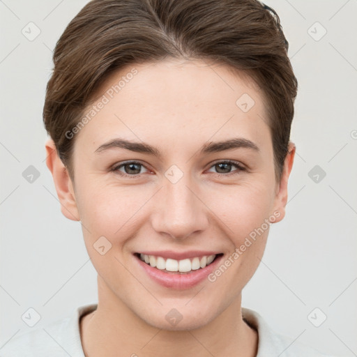 Joyful white young-adult female with short  brown hair and grey eyes