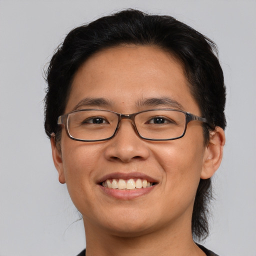 Joyful asian young-adult male with medium  brown hair and brown eyes