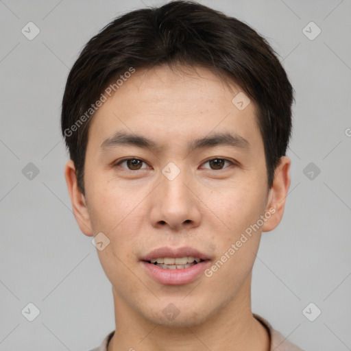 Joyful asian young-adult male with short  brown hair and brown eyes