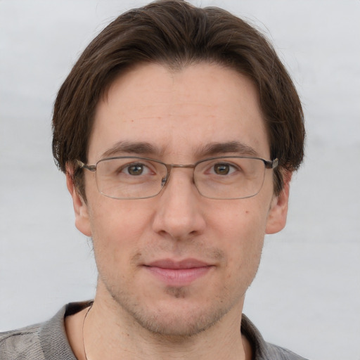 Joyful white adult male with short  brown hair and grey eyes