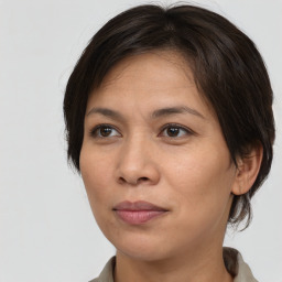 Joyful white adult female with medium  brown hair and brown eyes