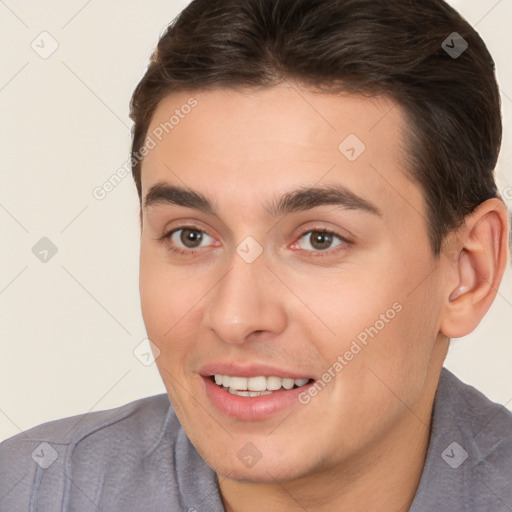 Joyful white young-adult male with short  brown hair and brown eyes