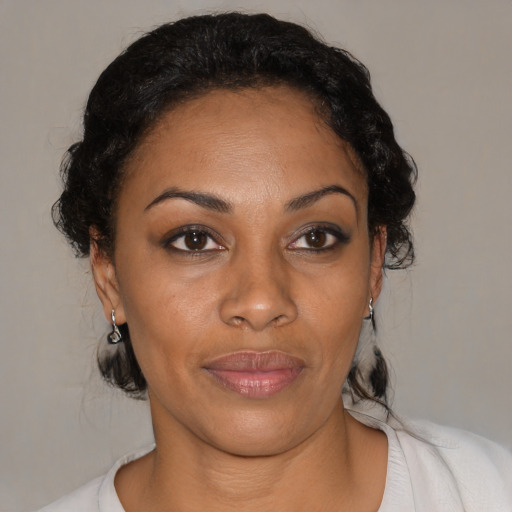 Joyful black adult female with medium  black hair and brown eyes