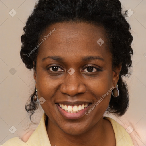 Joyful black adult female with long  brown hair and brown eyes