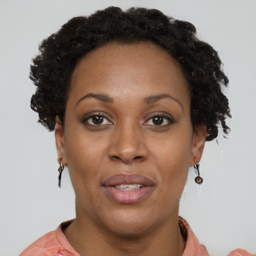 Joyful black young-adult female with short  brown hair and brown eyes
