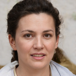 Joyful white adult female with medium  brown hair and brown eyes