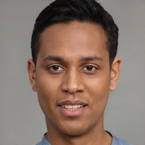 Joyful latino young-adult male with short  black hair and brown eyes