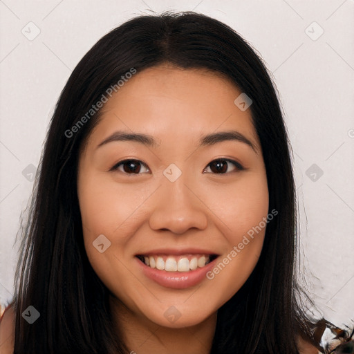 Joyful latino young-adult female with long  brown hair and brown eyes