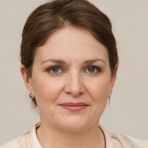 Joyful white adult female with medium  brown hair and brown eyes