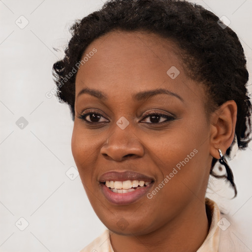 Joyful black young-adult female with short  brown hair and brown eyes