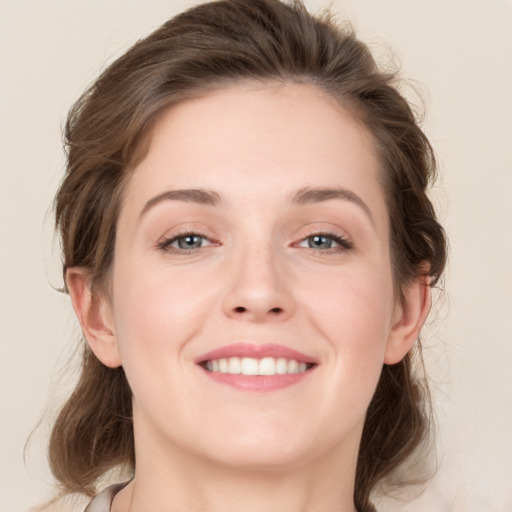 Joyful white young-adult female with medium  brown hair and grey eyes