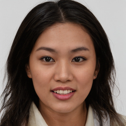 Joyful asian young-adult female with long  brown hair and brown eyes