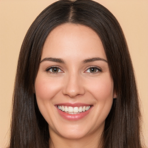 Joyful white young-adult female with long  brown hair and brown eyes