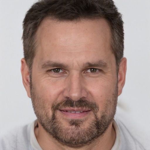 Joyful white adult male with short  brown hair and brown eyes