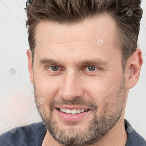 Joyful white adult male with short  brown hair and brown eyes