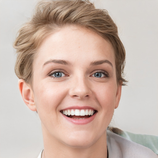 Joyful white young-adult female with short  brown hair and grey eyes