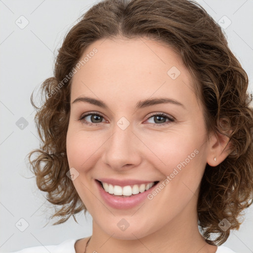 Joyful white young-adult female with medium  brown hair and green eyes