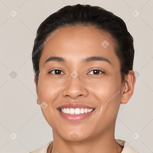 Joyful latino young-adult female with short  black hair and brown eyes