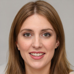 Joyful white young-adult female with long  brown hair and green eyes