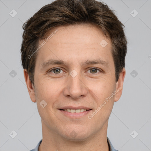 Joyful white adult male with short  brown hair and grey eyes