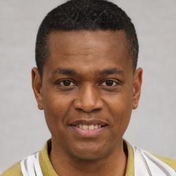 Joyful latino young-adult male with short  brown hair and brown eyes