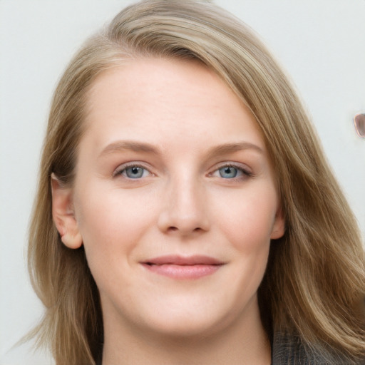 Joyful white young-adult female with long  brown hair and blue eyes