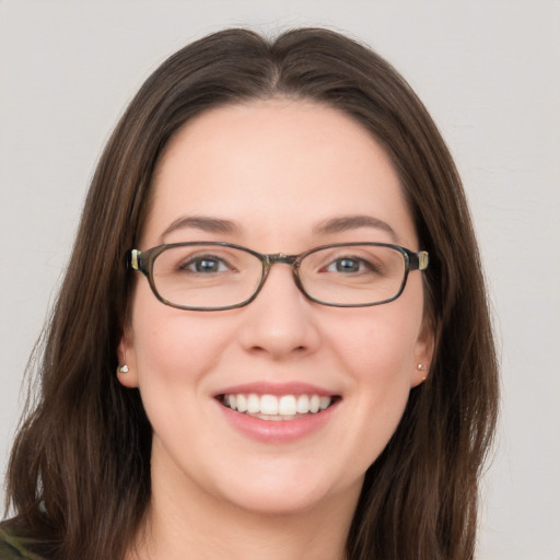 Joyful white young-adult female with long  brown hair and grey eyes